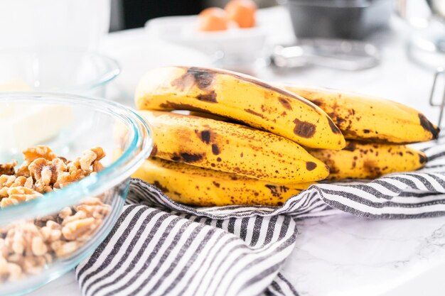 Mixing ingredients in kitchen mixer to bake banana nut bread.