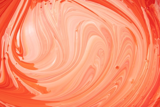 Mixing red dye into white paint abstract orange texture