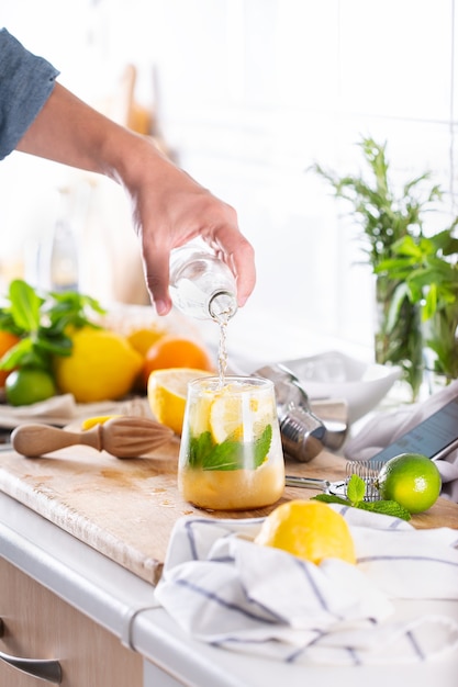 Mixologist making refreshing cocktail with hard seltzer at home