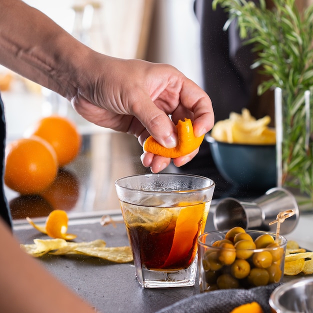 Mixologist che prepara cocktail rinfrescanti con vermouth a casa