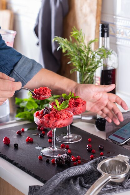 Mixologist making refreshing slushy or slushie cocktail at home