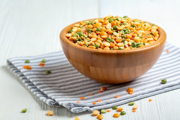 Mixture of dry legumes in a wooden bowl