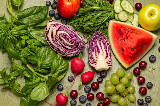 Mixture of fresh colored vegetables fruits berries and greens