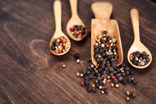 Mixture of peppers for cooking on a wooden background