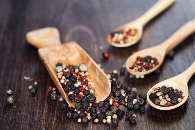 Mixture of peppers for cooking on a wooden background