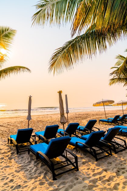 Mmbrella chair beach with palm tree and sea beach