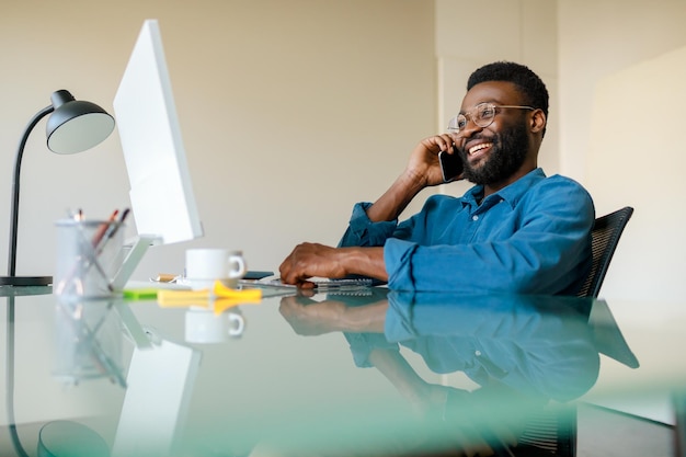 Mobile business communication and entrepreneurship black businessman talking on phone in front of