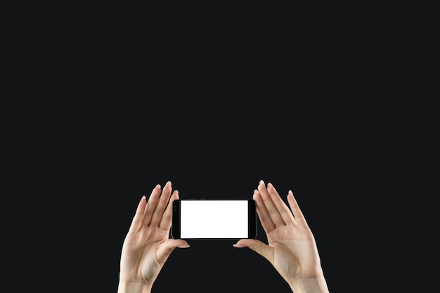 Photo mobile fun digital technology advertising background female hands holding smartphone with blank