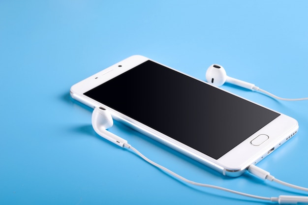  Mobile headphones and a mobile phone of white on blue