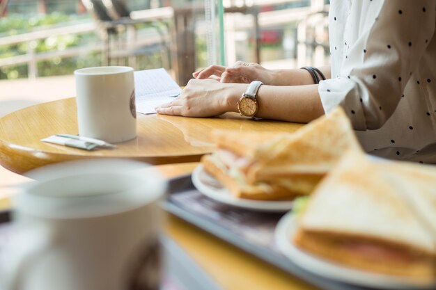 Photo mobile lifestyle. asian woman use smart phone for chat and work in coffee shop.