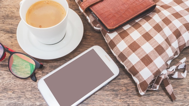 mobile phone and coffee on wooden floor