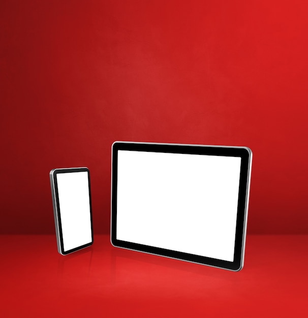 Mobile phone and digital tablet pc on red office desk.