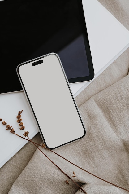 mobile phone screen with empty free copy space for mock up tablet dried grass on neutral beige linen cloth bright aesthetic social media branding online shopping template with neutral beige colour