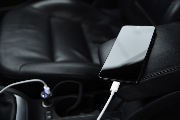 Mobile phone, smartphone charge battery, charging in the car\
plug close up