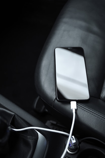 Mobile phone, smartphone charge battery , charging in the car plug close up