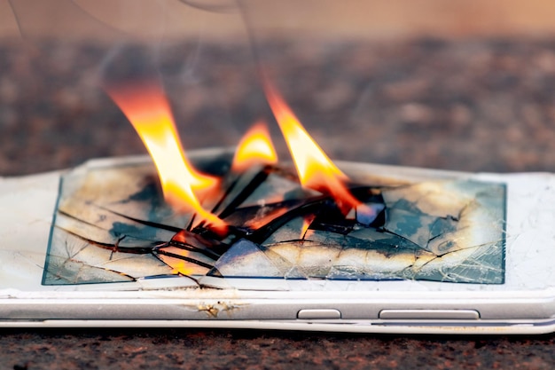 Mobile phone smartphone on fire burning smartphone
