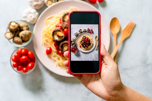 Mobile phone to take pictures of spaghettiTaking food photo