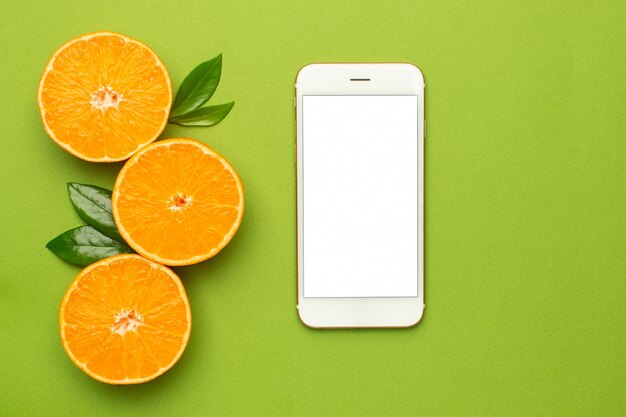 Mobile phone and tangerine, fruit flatlay, summer minimal composition