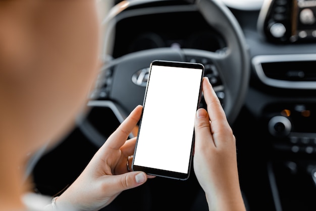 Photo mobile phone with blank screen in the hands of a woman