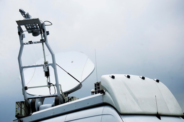 Mobile satellite communication vehicle for service and report news in event festival on Sanam Luang public garden park at Wat Phra Kaew temple or Wat Phra Si Rattana Satsadaram in Bangkok Thailand