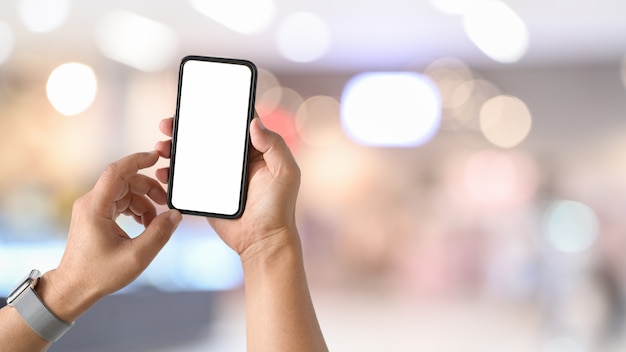 Mobile smart phone in man's hand at desk work.