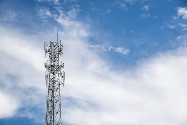Mobile towers on blue sky and white cloud background.