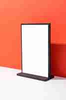 Photo mock up of blank menu frame stand for booklets with white sheets paper on red background with copy space