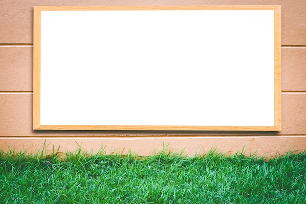 Mock up blank wooden picture frame on brick wall