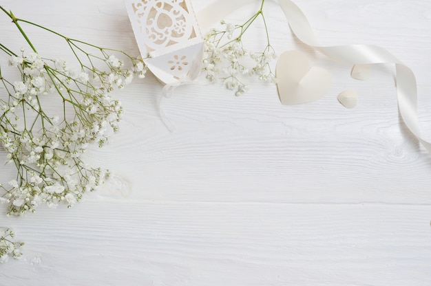 Photo mock up composition of white flowers rustic style, hearts and a gift for st. valentine's day with a place