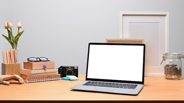 Mock up computer laptop books and pencil holder on wooden desk