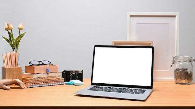 Mock up computer laptop books and pencil holder on wooden desk