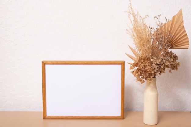 Mock up empty wooden frame mockup dried leaf and grass in vases on white background interior home design Art concept copy space