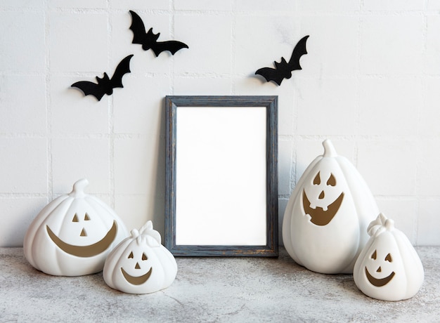 mock up  frame with jack o lantern and pumpkin decor on a table halloween concept