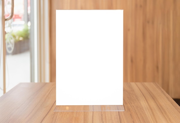 Photo mock up image of blank flyer mockup glass plastic transparent holder poster display in coffee shop