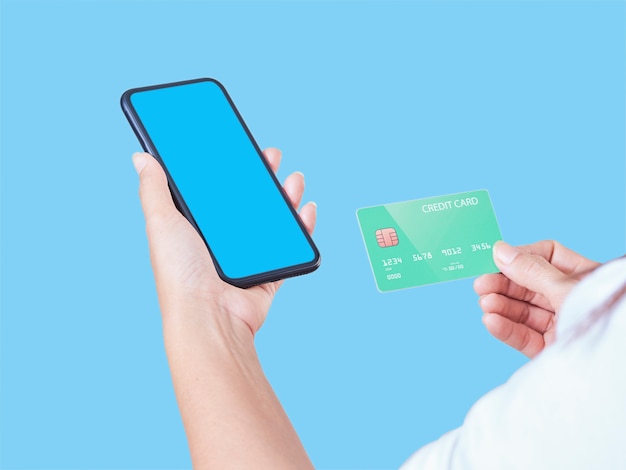 Mock-up image of woman hand holding mobile phone, blank screen and credit card