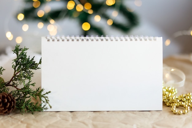 Foto mock-up kopie ruimte lege spiraal kalender met sprankelende gouden bokeh nieuwe boom backgroundxmas speelgoed