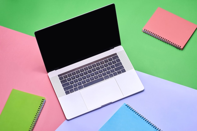 Photo mock up laptop, notebook on young student desk. cyan pastel colors.