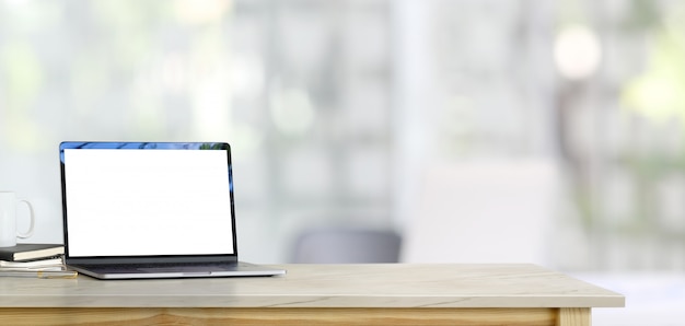 Mock up laptop on table in office