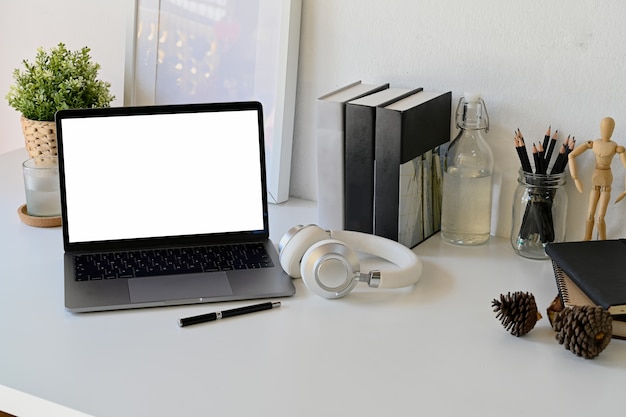 Mock up laptop on white work desk