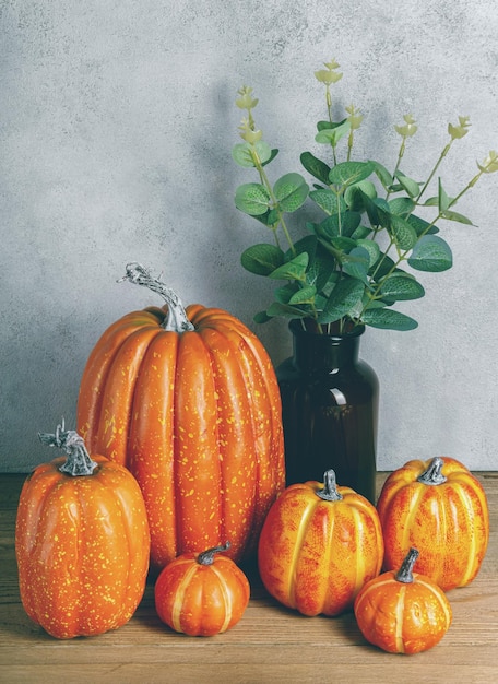 Mock up pumpkin with plant on wooden table Moody Style Halloween concept Autumn fall Copy space