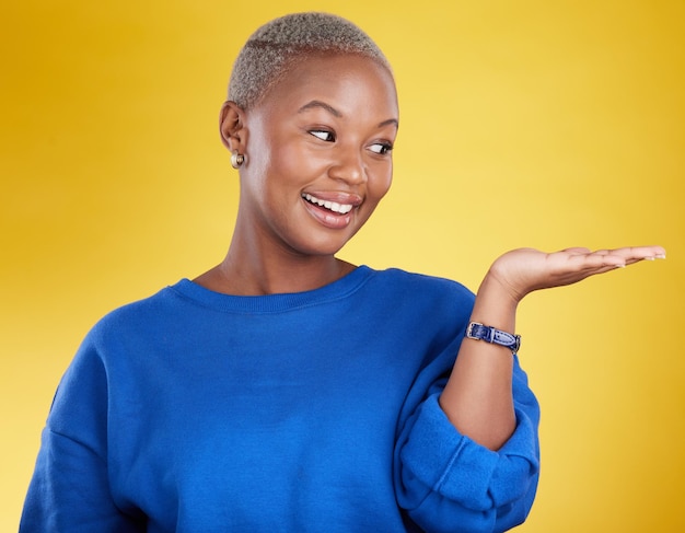 Mock up smile and black woman with product placement in studio isolated on a yellow background mockup promotion happy and african female with palm for advertising marketing and branding space