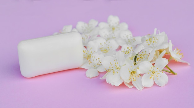 Mock up soap with flowers on pink background