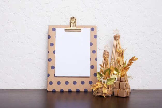 Mock up tablet with blank sheet paper and Christmas New Year decorations still life Xmas text blank