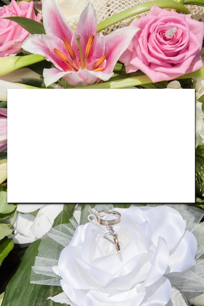 Photo mock-up wedding pastel pink flower rose bouquet and bride groom rings with white sheet paper empty space for marriage text mock up