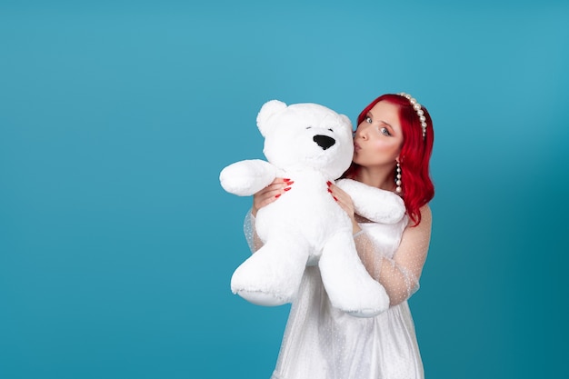 Mock up of  woman hugging a large white teddy bear and kissing it on the cheek