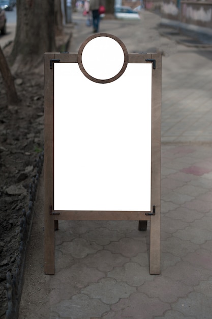 Mock up of wooden outdoor advertising stand.  Place for text, poster or public information.