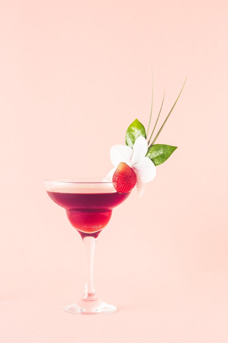 Mocktail decorated with strawberry, flower and tropical leaves,  selective focus.