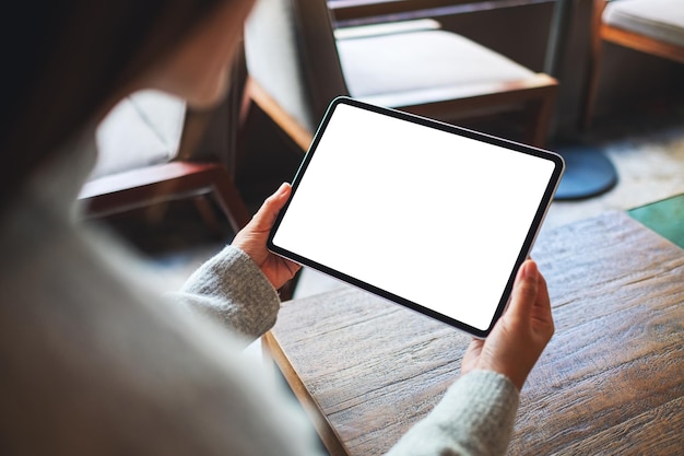 Mockup-afbeelding van een vrouw met een digitale tablet met een leeg wit bureaubladscherm