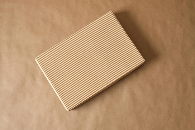 Mockup blank corrugated cardboard box on brown background top view