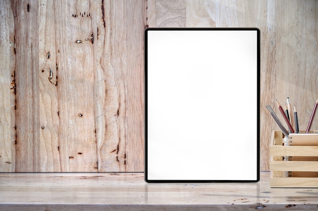 Mockup blank screen tablet on wooden table with copyspace for product display.